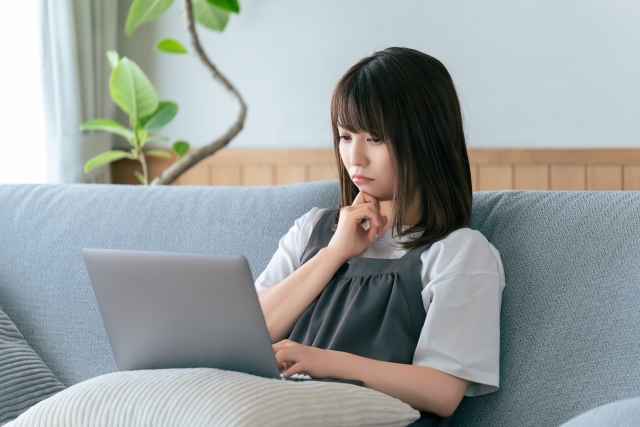 主婦がPCを見て悩んでいる様子